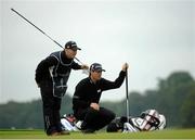 27 June 2013;  Team Ireland golfer Padraig Harrington, with his caddy Ronan Flood, left, lines up a putt on the 9th green during the Irish Open Golf Championship 2013. Carton House, Maynooth, Co. Kildare. Photo by: Oliver McVeigh / Sportsfile