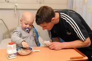 20 September 2010; Cork player, Eoin Cadogan, with Ciaran O'Sullivan aged 3 from Beara, Co. Cork, during a team visit at Our Lady's Hospital for Sick Children, Crumlin, Dublin. Picture credit: Barry Cregg / SPORTSFILE