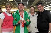 24 September 2010; Gerard McCormack, Ballymoate, Co. Sligo, shows off his gold medal for table tennis with from left, Mary McGill, May McCormack and Gerry McCormack,  on arrival home after Team Ireland's outstanding performance at the Special Olympics European Games in Warsaw, Poland. The athletes returned to Dublin airport with a medal tally of 10 Gold, 8 silver and 11 bronze medals, the team was greeted by cheers and tears from loved ones and supporters who turned out to applaud their outstanding performance at the games. Dublin Airport, Dublin. Picture credit: Barry Cregg / SPORTSFILE