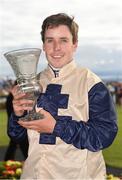 29 July 2016; Leigh Roche with the trophy after winning the Guinness Handicap on Golden Spear at the Galway Races in Ballybrit, Co Galway. Photo by Cody Glenn/Sportsfile