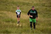 30 July 2016; Brendan Cummins of Tipperary is watched by his son Paul during the M Donnelly All-Ireland Poc Fada in the Annaverna Mountain, Ravensdale, Co Louth. Photo by Piaras Ó Mídheach/Sportsfile