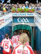 26 September 2010; The Tyrone team go back to the dressing-room as the Dublin players lift the Brendan Martin Cup. TG4 All-Ireland Senior Ladies Football Championship Final, Dublin v Tyrone, Croke Park, Dublin. Picture credit: Dáire Brennan / SPORTSFILE