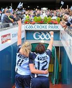 26 September 2010; Dublin players Amy McGuinness, left, and Lyndsey Peat, look on as Denise Masterson is about lift the Brendan Martin Cup. TG4 All-Ireland Senior Ladies Football Championship Final, Dublin v Tyrone, Croke Park, Dublin. Picture credit: Dáire Brennan / SPORTSFILE