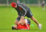28 September 2010; Munster's Alan Quinlan is helped stretch by strength and conditioning coach Paul Darbyshire during squad training ahead of their Celtic League match against Leinster on Saturday. Cork Institute of Technology, Bishopstown, Cork. Picture credit: Barry Cregg / SPORTSFILE