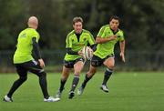 28 September 2010; Munster's Ronan O'Gara, centre, in action against team-mates Peter Stringer, left, and Doug Howlett during squad training ahead of their Celtic League match against Leinster on Saturday. Cork Institute of Technology, Bishopstown, Cork. Picture credit: Barry Cregg / SPORTSFILE