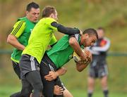 28 September 2010; Munster's Simon Zebo, right, is tackled by team-mates Tomas O'Leary, centre, and James Coughlan during squad training ahead of their Celtic League match against Leinster on Saturday. Cork Institute of Technology, Bishopstown, Cork. Picture credit: Barry Cregg / SPORTSFILE