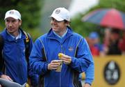29 September 2010; Rory Mcllroy, Team Europe, has some food and beverage as he makes his way down the 4th fairway. 2010 Ryder Cup - Practice Day, The Celtic Manor Resort, City of Newport, Wales. Picture credit: Matt Browne / SPORTSFILE