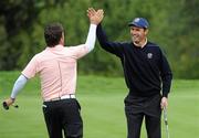 30 September 2010; Graeme McDowell congratulates Padraig Harrington after his eagle putt on the par four 15th green. 2010 Ryder Cup - Practice Day, The Celtic Manor Resort, City of Newport, Wales. Picture credit: Matt Browne / SPORTSFILE