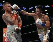 Jul 30 2016; Carl Frampton, left, of Northern Ireland exchanges punches with Leo Santa Cruz of Mexico during their WBA super world featherweight championship boxing match at the Barclays Center, Brooklyn, New York, USA. Photo by Noah K. Murray/Sportsfile