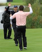 30 September 2010; Graeme McDowell, Team Europe, celebrates his birdie putt on the 14th green with playing partner Padraig Harrington. 2010 Ryder Cup - Practice Day, The Celtic Manor Resort, City of Newport, Wales. Picture credit: Matt Browne / SPORTSFILE
