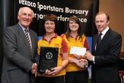 30 September 2010; Presenting Janet and Grace Clarke of Mossley Ladies Hockey Club, Newtownabbey, Co. Antrim,  with their award at the 2010 Texaco Sportstars Bursaries Awards Presentation are Eddie Keher, left, and Enda Riney, right, Country Chairman of Chevron Ireland. Conrad Hotel, Earlsfort Terrace, Dublin. Picture credit: Barry Cregg / SPORTSFILE