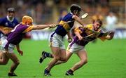 12 August 2001; Thomas Dunne of Tipperary in action against Michael Jordan, left, and Trevor Kelly of Wexford during the Guinness All-Ireland Senior Hurling Championship Semi-Final match between Wexford and Tipperary at Croke Park in Dublin. Photo by Damien Eagers/Sportsfile
