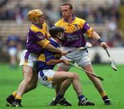 12 August 2001; Thomas Dunne of Tipperary is tackled by Michael Jordan, left, and Larry Murphy of Wexford during the Guinness All-Ireland Senior Hurling Championship Semi-Final match between Wexford and Tipperary at Croke Park in Dublin. Photo by Damien Eagers/Sportsfile