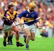12 August 2001; Liam Cahill of Tipperary in action against Adrian Fenlon of Wexford during the Guinness All-Ireland Senior Hurling Championship Semi-Final match between Wexford and Tipperary at Croke Park in Dublin. Photo by Damien Eagers/Sportsfile