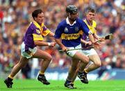 12 August 2001; Thomas Dunne of Tipperary in action against Adrian Fenlon of Wexford, left, during the Guinness All-Ireland Senior Hurling Championship Semi-Final match between Wexford and Tipperary at Croke Park in Dublin. Photo by Ray McManus/Sportsfile