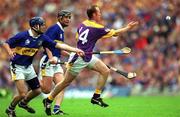 12 August 2001; Larry Murphy of Wexford in action against Paul Kelly, left, and Eddie Enright of Tipperary during the Guinness All-Ireland Senior Hurling Championship Semi-Final match between Wexford and Tipperary at Croke Park in Dublin. Photo by Ray McManus/Sportsfile