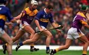 18 August 2001; John Carroll of Tipperary races past David O'Connor of Wexford to score his side's first goal during the Guinness All-Ireland Senior Hurling Championship Semi-Final Replay match between Wexford and Tipperary at Croke Park in Dublin. Photo by Ray McManus/Sportsfile