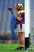 18 August 2001; Rory Mallon of Wexford drie his hurl with a towel as he waits alongside his goalkeeper Damien Fitzhenry for a Tipperary free during the Guinness All-Ireland Senior Hurling Championship Semi-Final Replay match between Wexford and Tipperary at Croke Park in Dublin. Photo by Ray McManus/Sportsfile