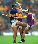 18 August 2001; Eddie Enright of Tipperary in action against Darren Stamp and Adrian Fenlon, behind, of Wexford during the Guinness All-Ireland Senior Hurling Championship Semi-Final Replay match between Wexford and Tipperary at Croke Park in Dublin. Photo by Ray McManus/Sportsfile