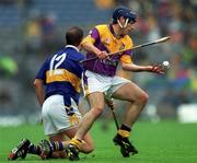 18 August 2001; Liam Dunne of Wexford in action against Brian O'Meara of Tipperary during the Guinness All-Ireland Senior Hurling Championship Semi-Final Replay match between Wexford and Tipperary at Croke Park in Dublin. Photo by Ray McManus/Sportsfile