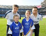 27 September 2010; Katie Ring and Jessica Beechinor, from Cork, with Kildare manager Kieran McGeeney and Cavan footballer Paul Brady. Vhi GAA Cúl Day Out 2010, Croke Park, Dublin. Picture credit: Oliver McVeigh / SPORTSFILE