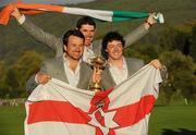 4 October 2010; Graeme McDowell and Rory Mcllroy, Team Europe, have their picture taken with the Ryder Cup as team-mate Padraig Harring jumps into the backround. The 2010 Ryder Cup, The Celtic Manor Resort, City of Newport, Wales. Picture credit: Matt Browne / SPORTSFILE