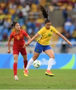 3 August 2016; Beatriz of Brazil in action against Ruyin Tan of China during the Women's Football first round Group E match between Brazil and China on Day -2 of the Rio 2016 Olympic Games at the Olympic Stadium in Rio de Janeiro, Brazil. Photo by Stephen McCarthy/Sportsfile