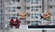 3 August 2016; Workers look on as divers train in the Maria Lenk Aquatics Centre ahead of the start of the 2016 Rio Summer Olympic Games in Rio de Janeiro, Brazil. Photo by Brendan Moran/Sportsfile