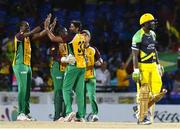3 August 2016; Steven Jacobs (L) and Sohail Tanvir (R) of Guyana Amazon Warriors celebrate the dismissal of Andre Russell (R) of Jamaica Tallawahs during the Hero Caribbean Premier League match between Guyana Amazon Warriors and Jamaica Tallawahs - Hero Caribbean Premier League (CPL) – Play-off - Match 31 at Warner Park in Basseterre, St Kitts. Photo by Randy Brooks/Sportsfile