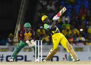 3 August 2016; Rovman Powell (R) of Jamaica Tallawahs hits 6 during the Hero Caribbean Premier League match between Guyana Amazon Warriors and Jamaica Tallawahs - Hero Caribbean Premier League (CPL) – Play-off - Match 31 at Warner Park in Basseterre, St Kitts. The keeper is Anthony Bramble (L) of Guyana Amazon Warriors.  Photo by Randy Brooks/Sportsfile