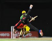 5 August 2016;  Dwayne Bravo of Trinbago Knight Riders attempts to stop the ball off Andre Russell of Jamaica Tallawahs during the Hero Caribbean Premier League (CPL) – Play-off - Match 33 at Warner Park in Basseterre, St Kitts. Photo by Randy Brooks/Sportsfile
