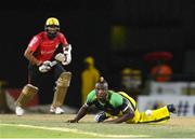 5 August 2016;  Andre Russell (R) of Jamaica Tallawahs attempts to stop the ball played by Hashim Amla (L) of Trinbago Knight Riders during the Hero Caribbean Premier League (CPL) – Play-off - Match 33 at Warner Park in Basseterre, St Kitts. Photo by Randy Brooks/Sportsfile
