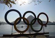 6 August 2016; A rower passes through the Olympic rings following the Men's Single Sculls heats in Lagoa Stadium, Copacabana, during the 2016 Rio Summer Olympic Games in Rio de Janeiro, Brazil. Photo by Ramsey Cardy/Sportsfile