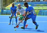 6 August 2016; Raghunath Vokkaliga of India in action against Eugene Magee of Ireland during their Pool B match at the Olympic Hockey Centre, Deodoro, during the 2016 Rio Summer Olympic Games in Rio de Janeiro, Brazil. Photo by Brendan Moran/Sportsfile