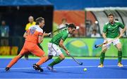 7 August 2016; Jonathan Bell of Ireland in action against Bob de Voogd of Netherlands during their Pool B match at the Olympic Hockey Centre, Deodoro, during the 2016 Rio Summer Olympic Games in Rio de Janeiro, Brazil. Picture by Brendan Moran/Sportsfile