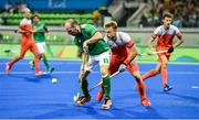 7 August 2016; Peter Caruth of Ireland in action against Mink van der Weerden of Netherlands during their Pool B match at the Olympic Hockey Centre, Deodoro, during the 2016 Rio Summer Olympic Games in Rio de Janeiro, Brazil. Photo by Brendan Moran/Sportsfile