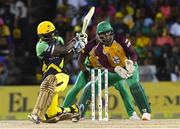 7 August 2016; Chadwick Walton (L) of Jamaica Tallawahs hits 4 during Match 34 of the Hero Caribbean Premier League (CPL) – Final at Warner Park in Basseterre, St Kitts. The keeper is Anthony Bramble (R) of Guyana Amazon Warriors. Photo by Randy Brooks/Sportsfile