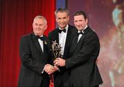 15 October 2010; Brendan Cummins, Tipperary, is presented with his GAA Hurling All-Star award by Uachtarán Chumann Lúthchleas Gael Criostóir Ó Cuana and Jeroen Hoencamp, CEO, Vodafone Ireland, during the 2010 GAA All-Stars Awards, sponsored by Vodafone. Citywest Hotel & Conference Centre, Saggart, Co. Dublin. Picture credit: Brendan Moran / SPORTSFILE