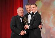 15 October 2010; Michael Walsh, Waterford, is presented with his GAA Hurling All-Star award by Uachtarán Chumann Lúthchleas Gael Criostóir Ó Cuana and Jeroen Hoencamp, CEO, Vodafone Ireland, during the 2010 GAA All-Stars Awards, sponsored by Vodafone. Citywest Hotel & Conference Centre, Saggart, Co. Dublin. Picture credit: Brendan Moran / SPORTSFILE