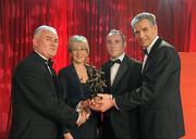 15 October 2010; Eoin Kelly, Tipperary, is presented with his GAA Hurling All-Star award by Uachtarán Chumann Lúthchleas Gael Criostóir Ó Cuana and Jeroen Hoencamp, CEO, Vodafone Ireland, during the 2010 GAA All-Stars Awards, sponsored by Vodafone. Citywest Hotel & Conference Centre, Saggart, Co. Dublin. Picture credit: Ray McManus / SPORTSFILE
