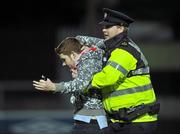 19 October 2010; A supporters is taken away by a member of the Garda Siochana at the end of the game. FAI Ford Cup Semi-Final Replay, St Patrick's Athletic v Shamrock Rovers, Richmond Park, Inchicore, Dublin. Picture credit: SPORTSFILE