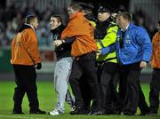 19 October 2010; A supporters is taken away by security staff and a member of the Garda Siochana at the end of the game. FAI Ford Cup Semi-Final Replay, St Patrick's Athletic v Shamrock Rovers, Richmond Park, Inchicore, Dublin. Picture credit: SPORTSFILE