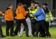 19 October 2010; Gardai and stewards restrain a football supporter after he encroached on the pitch. FAI Ford Cup Semi-Final Replay, St Patrick's Athletic v Shamrock Rovers, Richmond Park, Inchicore, Dublin. Picture credit: SPORTSFILE