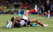 11 August 2016; Osea Kolinisau of Fiji goes over to score his side's first try despite the tackle of Tom Mitchell of Great Britain during the Men's Rugby Sevens gold medal match between Fiji and Great Britain during the 2016 Rio Summer Olympic Games at Deodoro Stadium in Rio de Janeiro, Brazil. Photo by Stephen McCarthy/Sportsfile