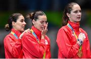 11 August 2016; Simona Gherman, centre, of Romania sheds a tear on the podium alongside team-mates Loredana Dinu, left, and Simona Pop during the Women's Épée Team Gold Medal Match in Carioca Arena 3 during the 2016 Rio Summer Olympic Games in Rio de Janeiro, Brazil. Photo by Ramsey Cardy/Sportsfile