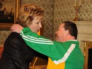 27 October 2010; TEAM Ireland member Hugh Mohan, from Tubbercurry, Co. Sligo, who won Gold in the 400m walk and silver in the 800m walk in the athletics competition at the 2010 Special Olympics European Games, gives President Mary McAleese a hug at a reception to celebrate their achievements in Aras an Uachtarain, Phoenix Park, Dublin. Picture credit: Ray McManus / SPORTSFILE
