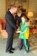 27 October 2010; TEAM Ireland member Mary Melia  , from Claremorris, Co. Mayo, who came Fourth in the 50m race and won a gold medal in the softball throw competition at the 2010 Special Olympics European Games, with President Mary McAleese and Dr. Martin McAleese at a reception to celebrate their achievements in Aras an Uachtarain, Phoenix Park, Dublin. Picture credit: Ray McManus / SPORTSFILE