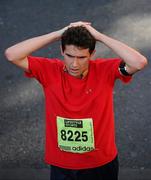 25 October 2010; Andrew Roache, from Edinburgh, Scotland, reacts after completing the Lifestyle Sports - adidas Dublin Marathon 2010. Dublin. Picture credit: Stephen McCarthy / SPORTSFILE