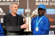 25 October 2010; Mens winner Moses Kangogo Kibet, Kenya, who won in a record time of 2:08:58, is presented with the Noel Carroll perpetual trophy, by Noel Carroll Jnr., at the Lifestyle Sports - adidas Dublin Marathon 2010. Dublin. Picture credit: Stephen McCarthy / SPORTSFILE