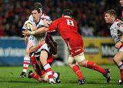 29 October 2010; Ruan Pienaar, Ulster, is tackled by Muster forwards Billy Holland and James Coughlan. Celtic League, Ulster v Munster, Ravenhill Park, Belfast. Picture credit: John Dickson / SPORTSFILE